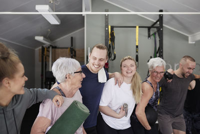 Happy people in gym looking at camera