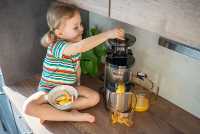 Portrait of boy eating food at home