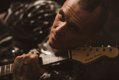 Portrait of man playing guitar