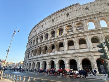 Tourists at historical building against sky