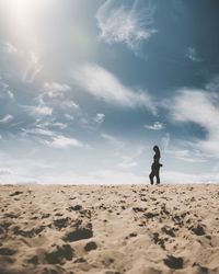 Full length of man on sand at beach against sky