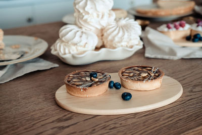 Round brown cake with nuts and caramel. still life with cakes on the table, close-up