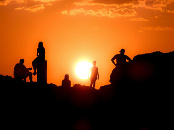 Silhouette people at sunset