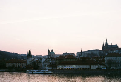 River in city against clear sky