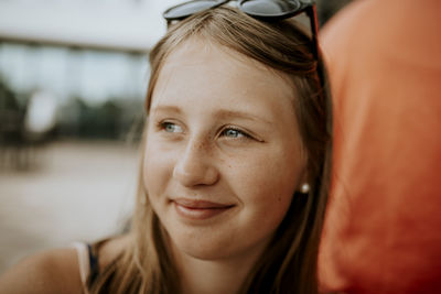 Smiling teenage girl looking away