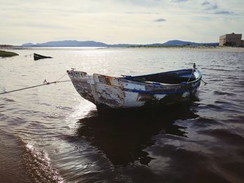 Boats moored on sea against sky