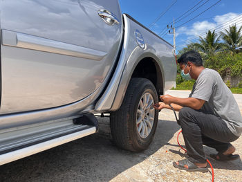 The man inspected the car to make sure it was ready for use and safe