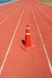 High angle view of traffic cone on running track