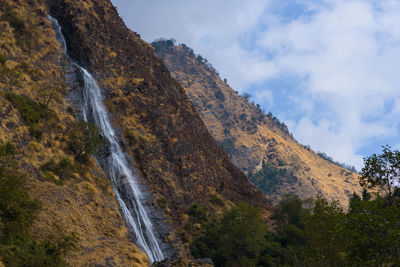 Scenic view of waterfall against sky