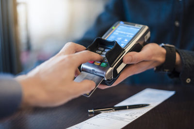 Man using credit card reader, close-up