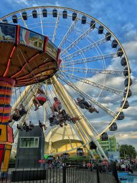 Low angle view of ferris wheel against sky