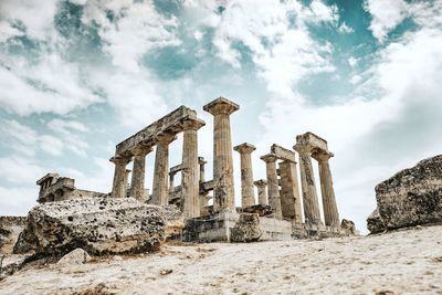 Old ruins of temple against cloudy sky