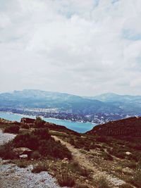 Scenic view of mountains against cloudy sky