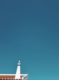 Low angle view of built structure against clear blue sky