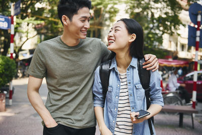 Young couple smiling in city