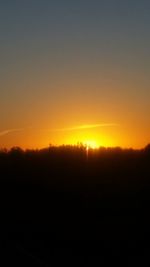 Scenic view of silhouette landscape against clear sky at sunset