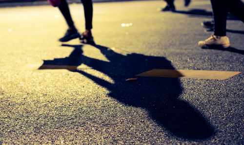 Low section of people walking on road