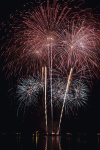 Low angle view of firework display at night