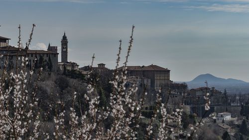 Panoramic view of buildings in city against sky