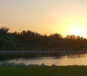 Scenic view of lake against sky during sunset