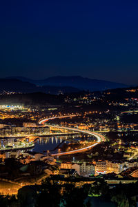 High angle view of illuminated buildings in city at night