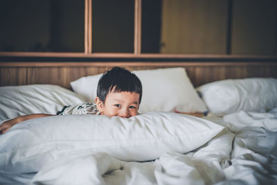 Cute boy lying on bed