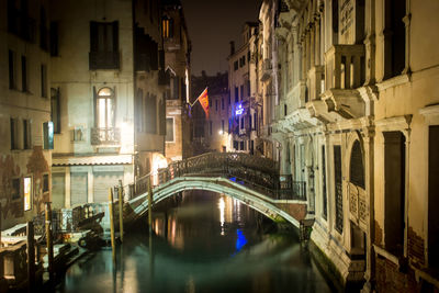 Canal passing through city at night