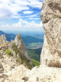 Scenic view of rocky mountains against cloudy sky