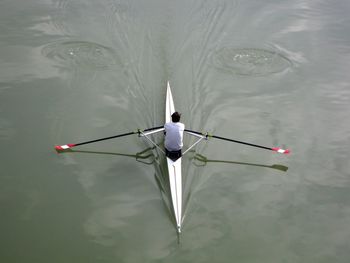 Rear view of man in boat sailing on lake