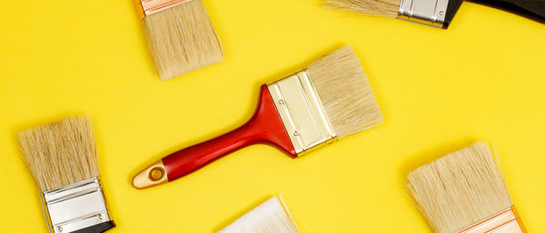 Directly above shot of beauty products on yellow background