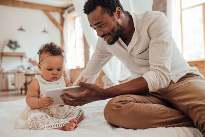 Midsection of father with son at home