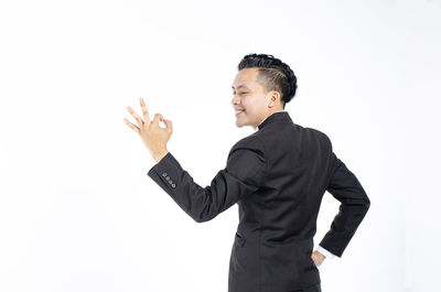 Man looking away against white background