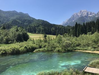 Scenic view of lake and mountains against sky