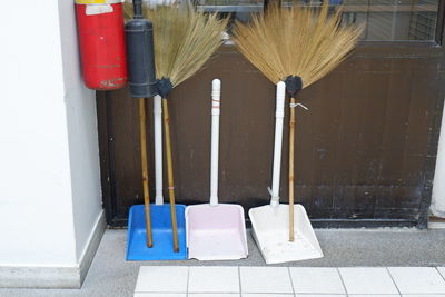 Close-up of deck chairs on footpath against building