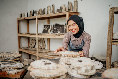 Portrait of young woman standing in workshop