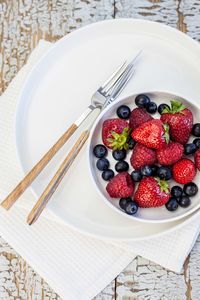 High angle view of strawberries in plate on table