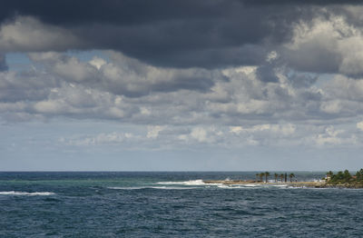 Scenic view of sea against cloudy sky