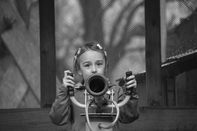 Portrait of boy holding camera