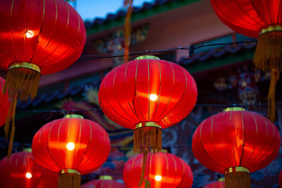 Low angle view of illuminated lanterns hanging at night