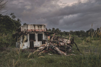 Abandoned built structure on field against sky