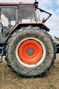 Modern tractor placed on agricultural field in mountainous area in summer