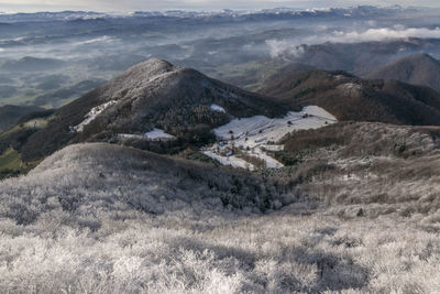 High angle view of land and mountains against sky