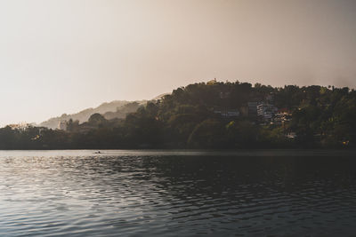 Scenic view of lake against clear sky during sunset