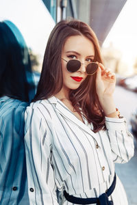 Portrait of young woman wearing sunglasses