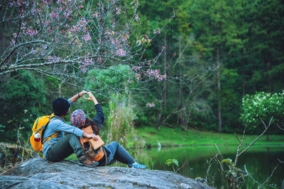 Men sitting on land in forest