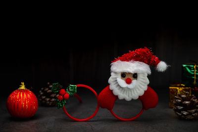 Close-up of christmas decorations against black background