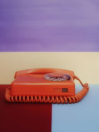 Close-up of telephone booth against blue sky