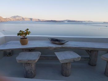 Scenic view of table by sea against clear sky