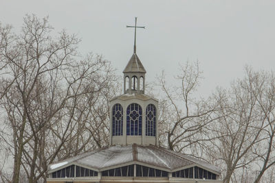 Low angle view of building and trees against sky