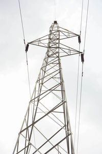 Low angle view of electricity pylon against sky